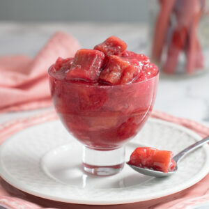 a glass bowl filled with rhubarb compote.