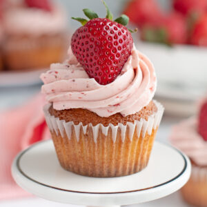 a strawberry cupcake on a white plate.