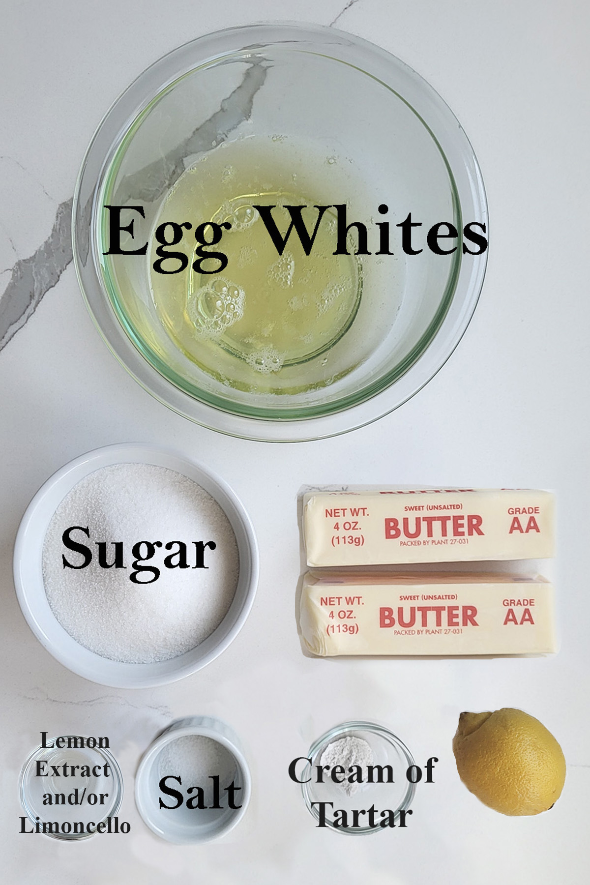 ingredients for lemon buttercream in glass bowls on a white surface.
