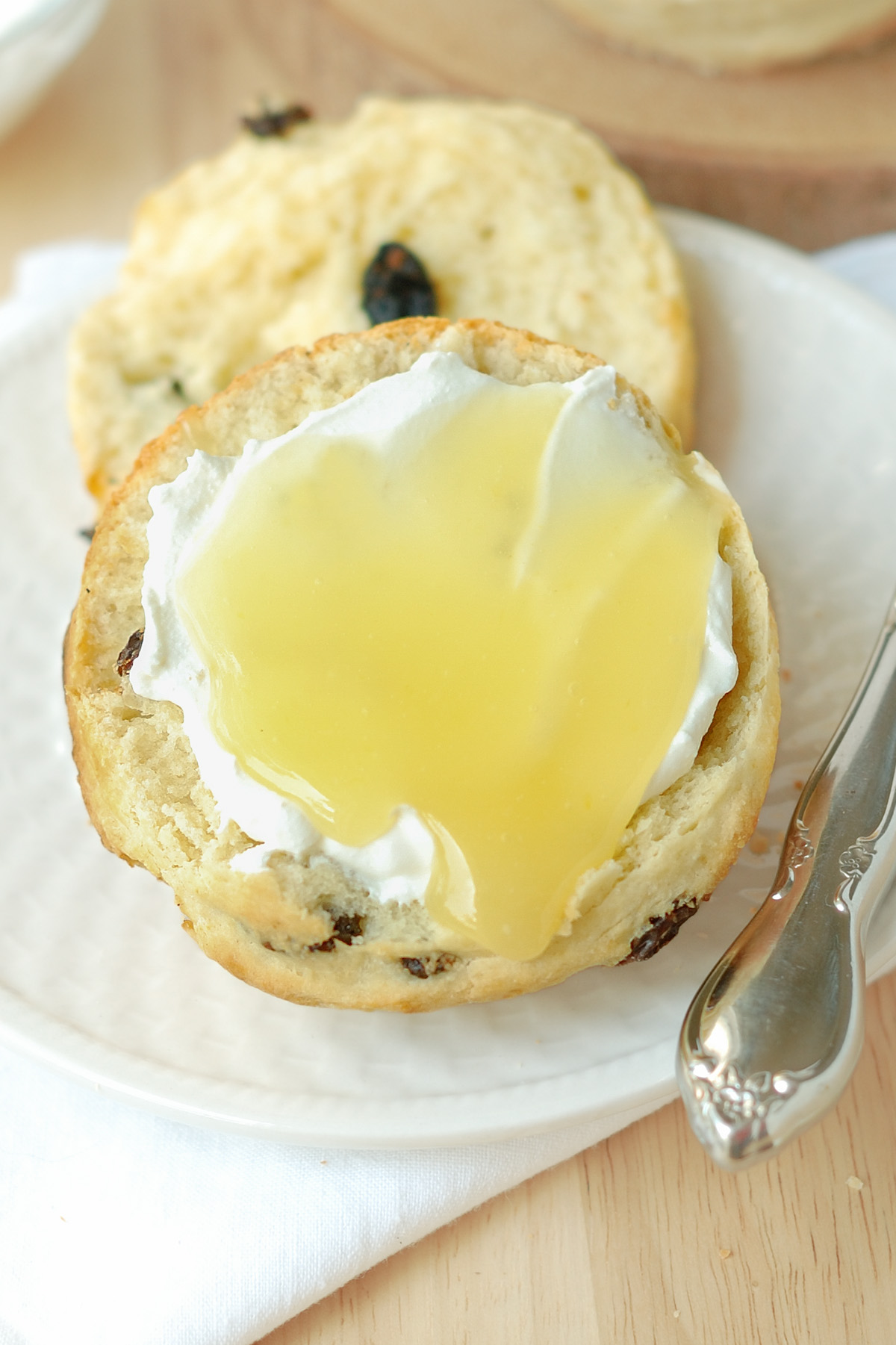 a scone with cream and lemon curd.