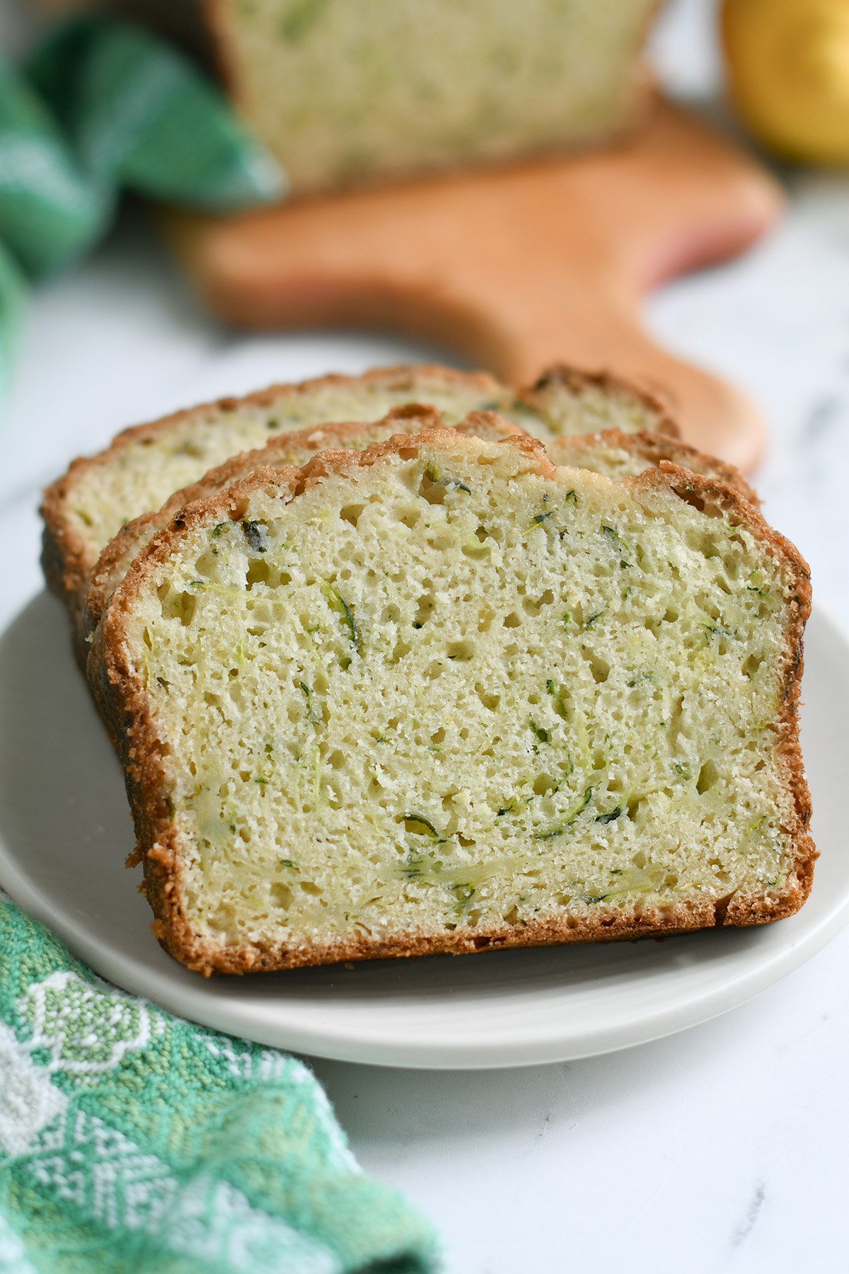 slices of sourdough zucchini bread on a white plate. 