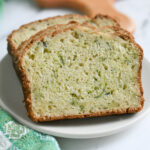 slices of sourdough zucchini bread on a white plate.