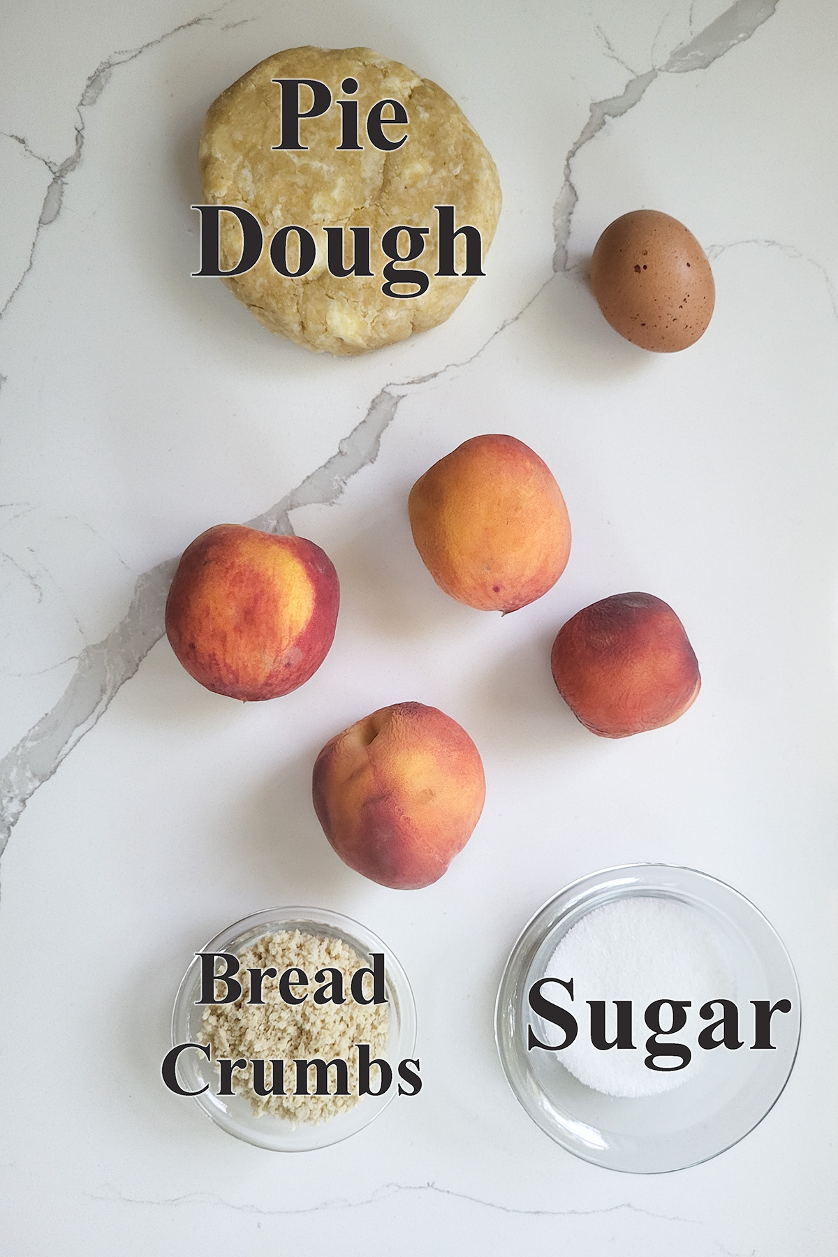 ingredients for peach galette on a white surface.
