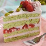 a pinterest image for pistachio raspberry layer cake with text overlay.