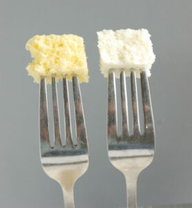 two forks with a piece of cake on each.
