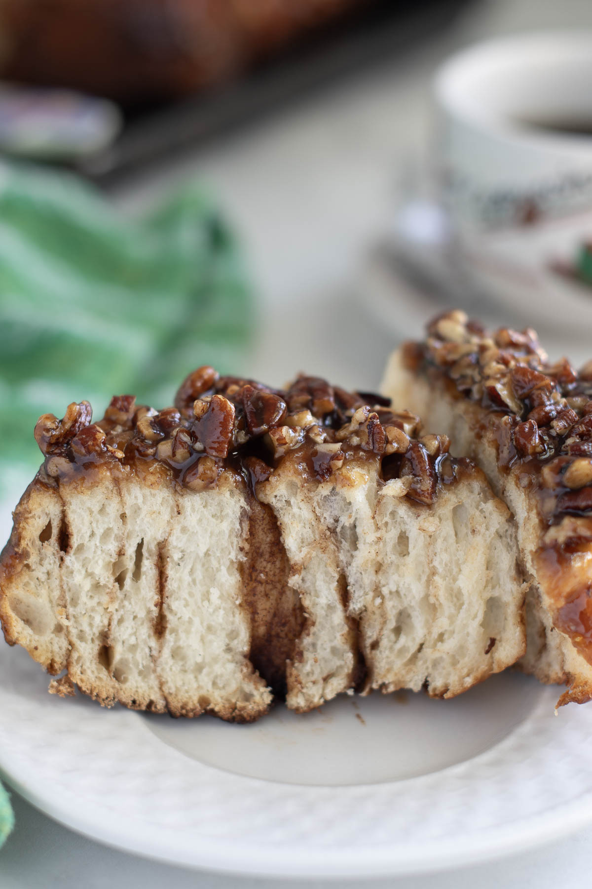 A SLICED sourdough sticky bun on a white plate.