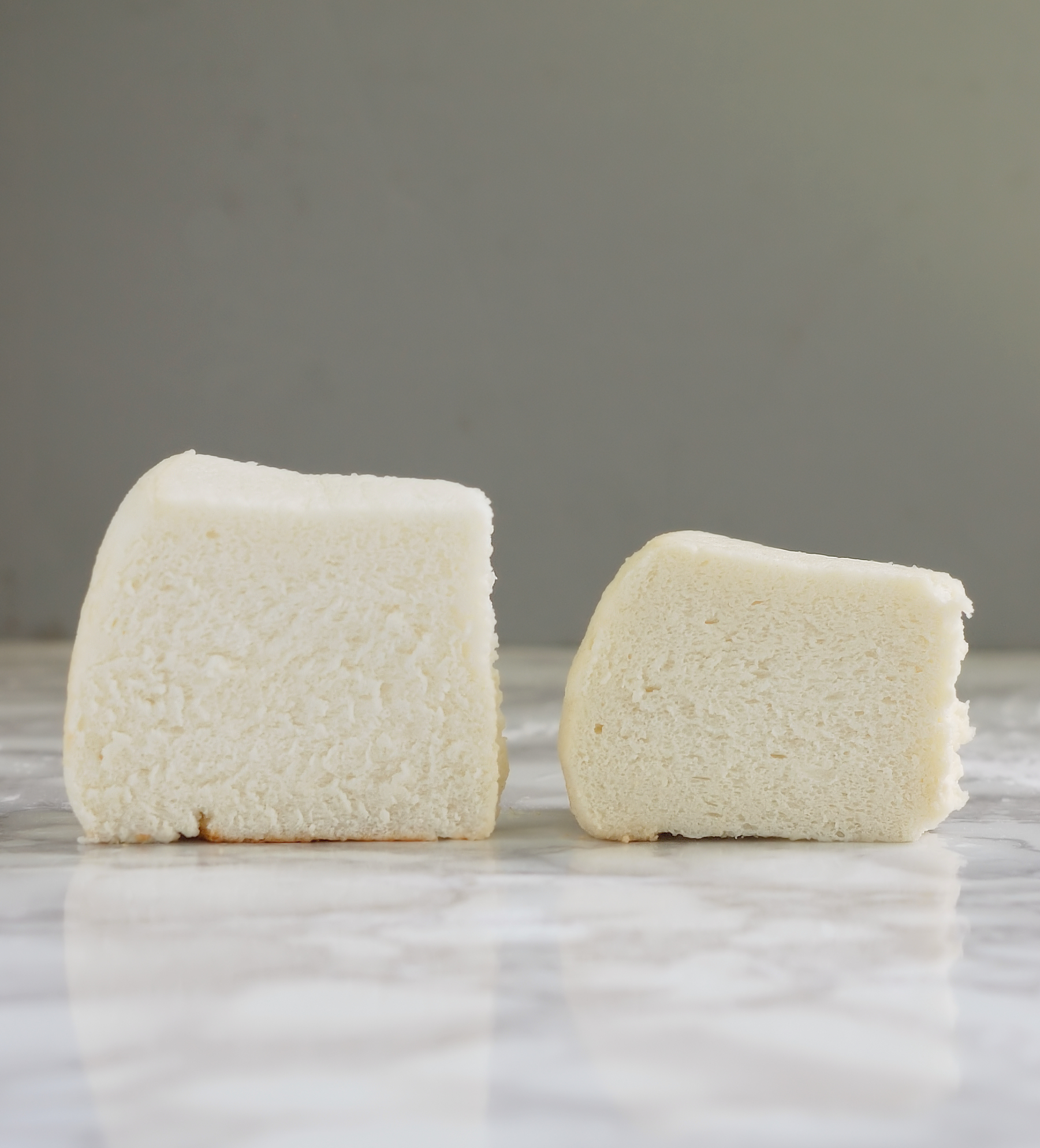 two pieces of angel food cake, one taller.