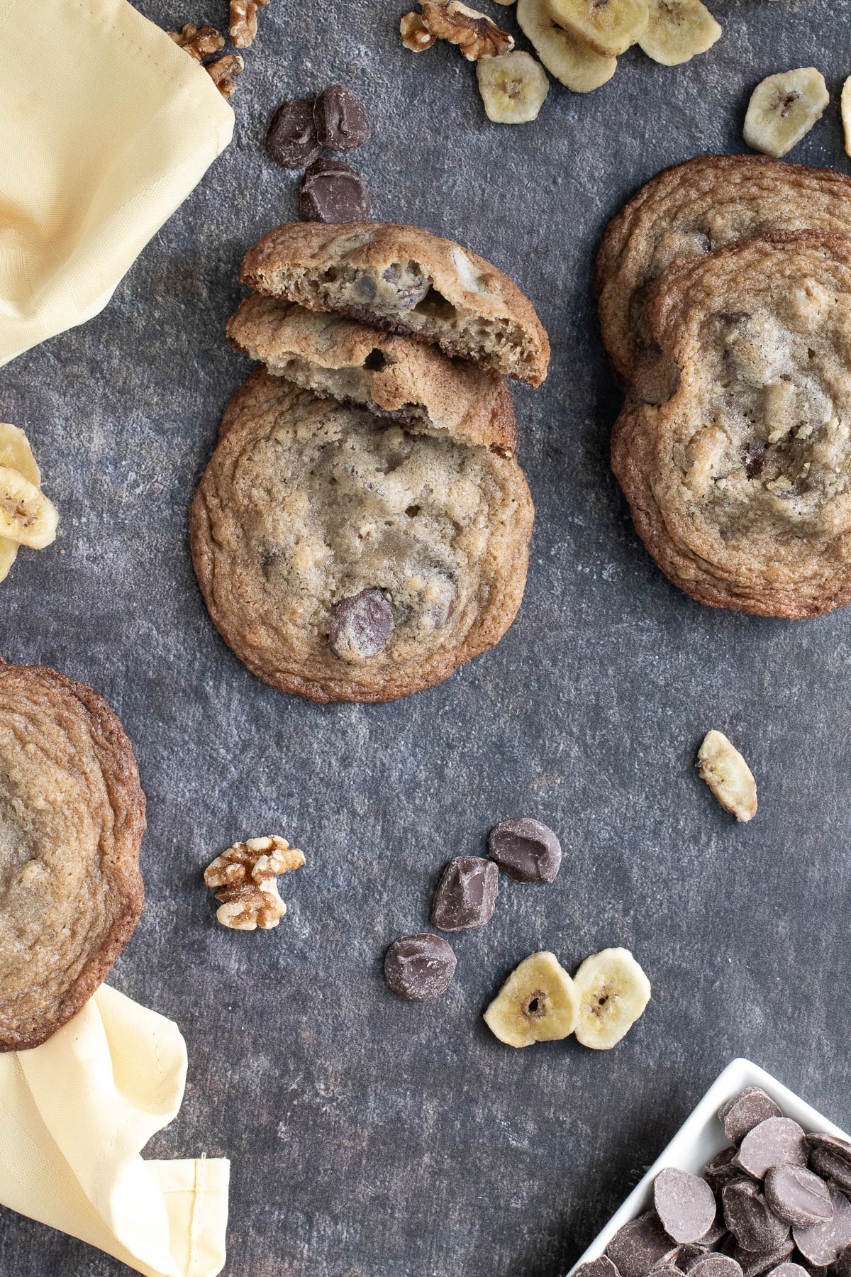 banana chocolate chip cookies on a black surface.
