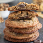 a stack of banana chocolate chunk cookies on a black surface.