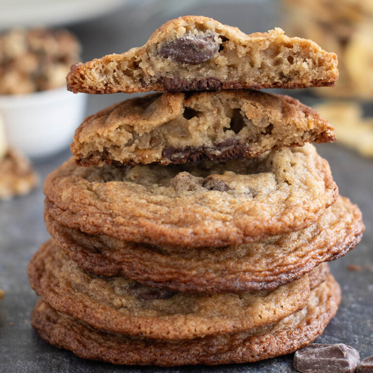 a stack of banana chocolate chunk cookies on a black surface.