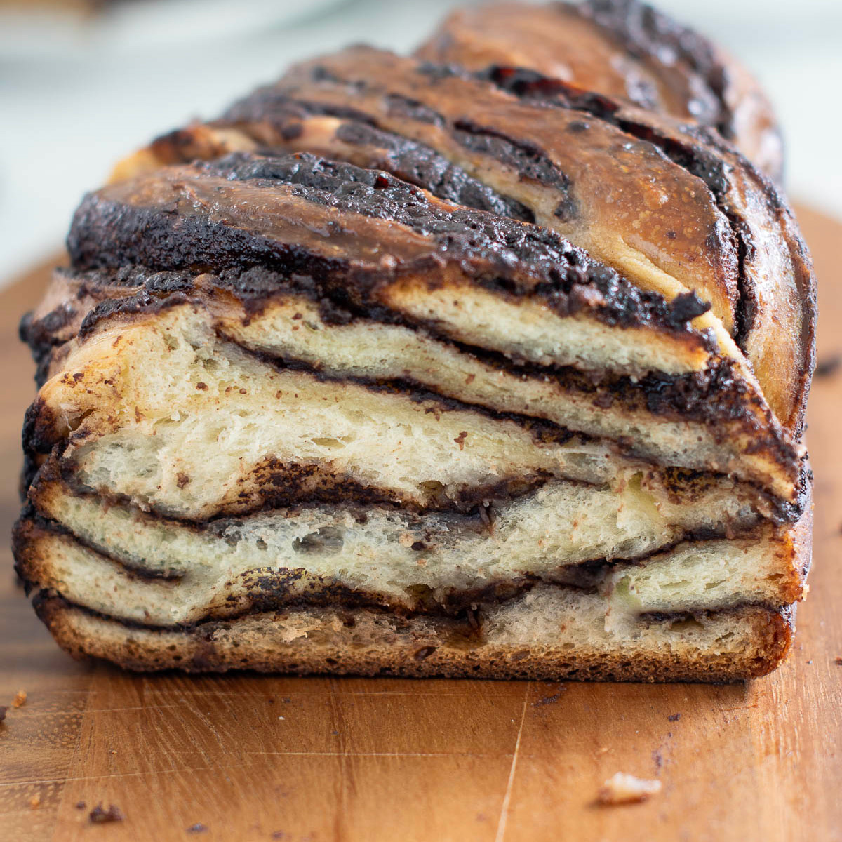 a sliced chocolate babka on a cutting board.