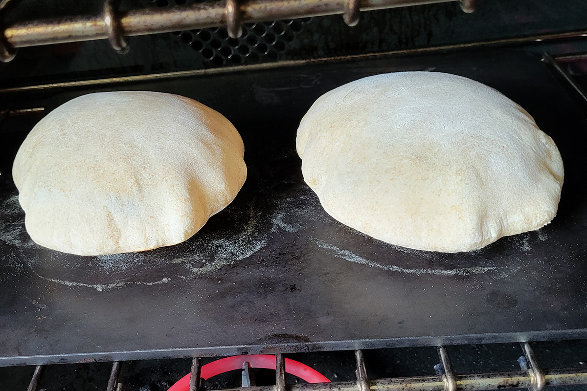 pita bread in an oven.