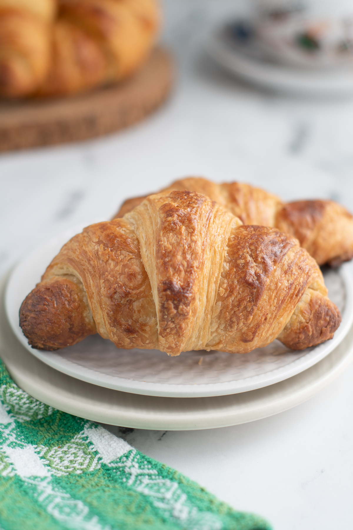 a croissant on a white plate.