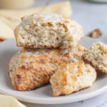 a banana scones cut in half on a white plate.