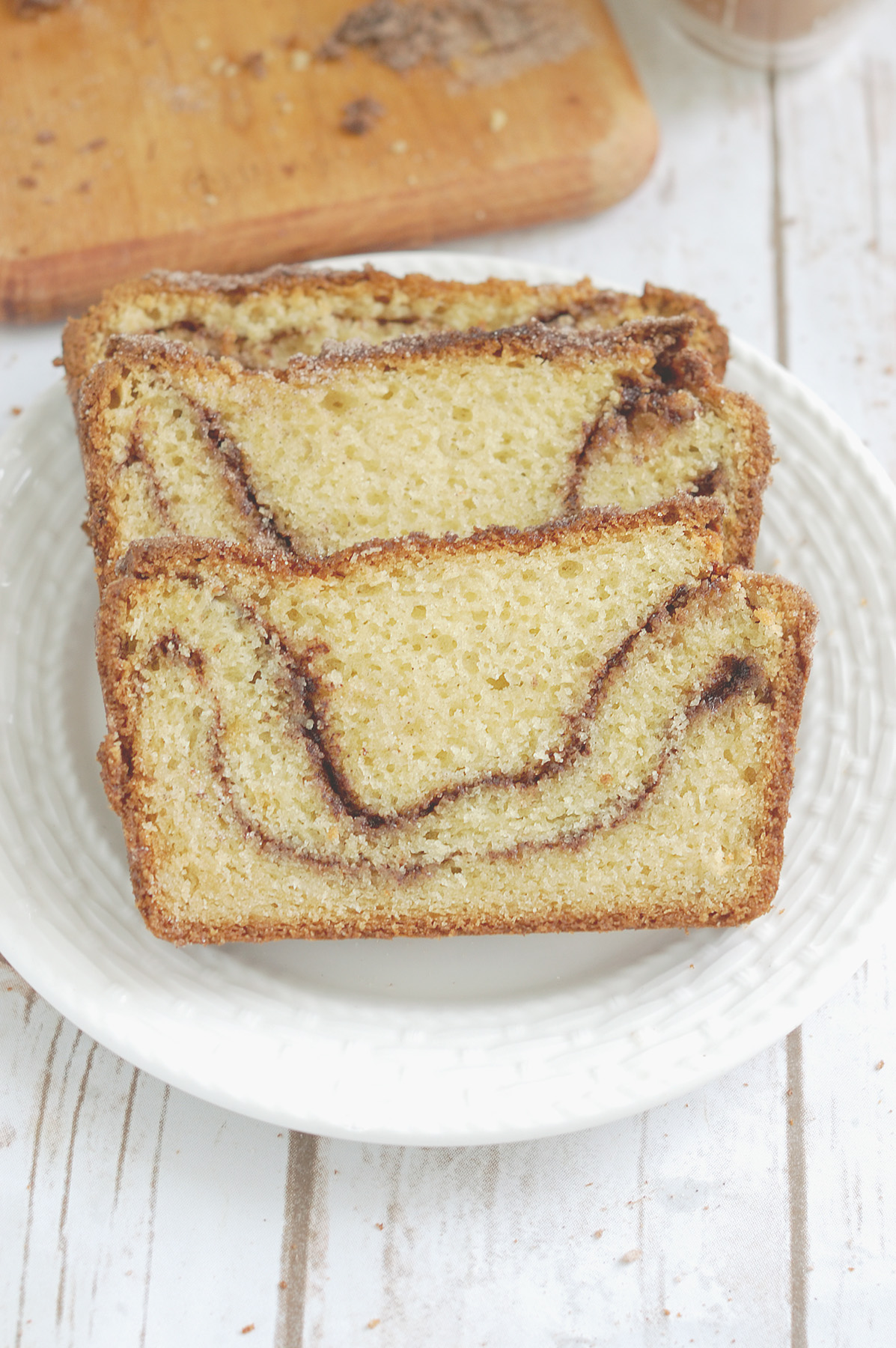 two slices of snickerdoodle bread on a white plate.
