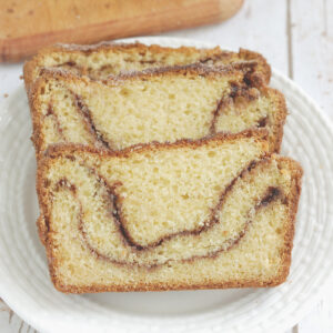 three slices of snickerdoodle bread on a white plate.