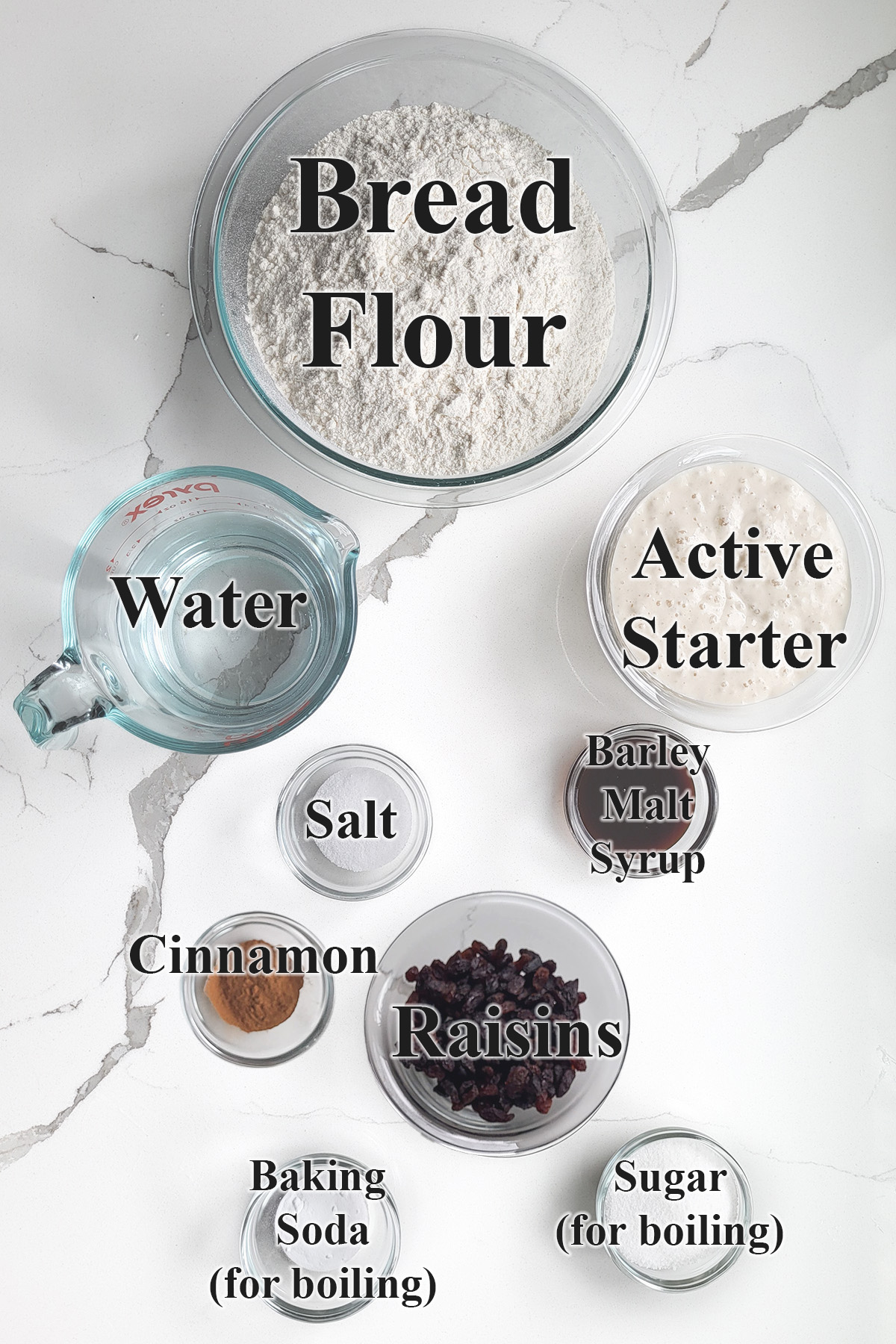 ingredients for sourdough cinnamon raisin bagels in glass bowls.