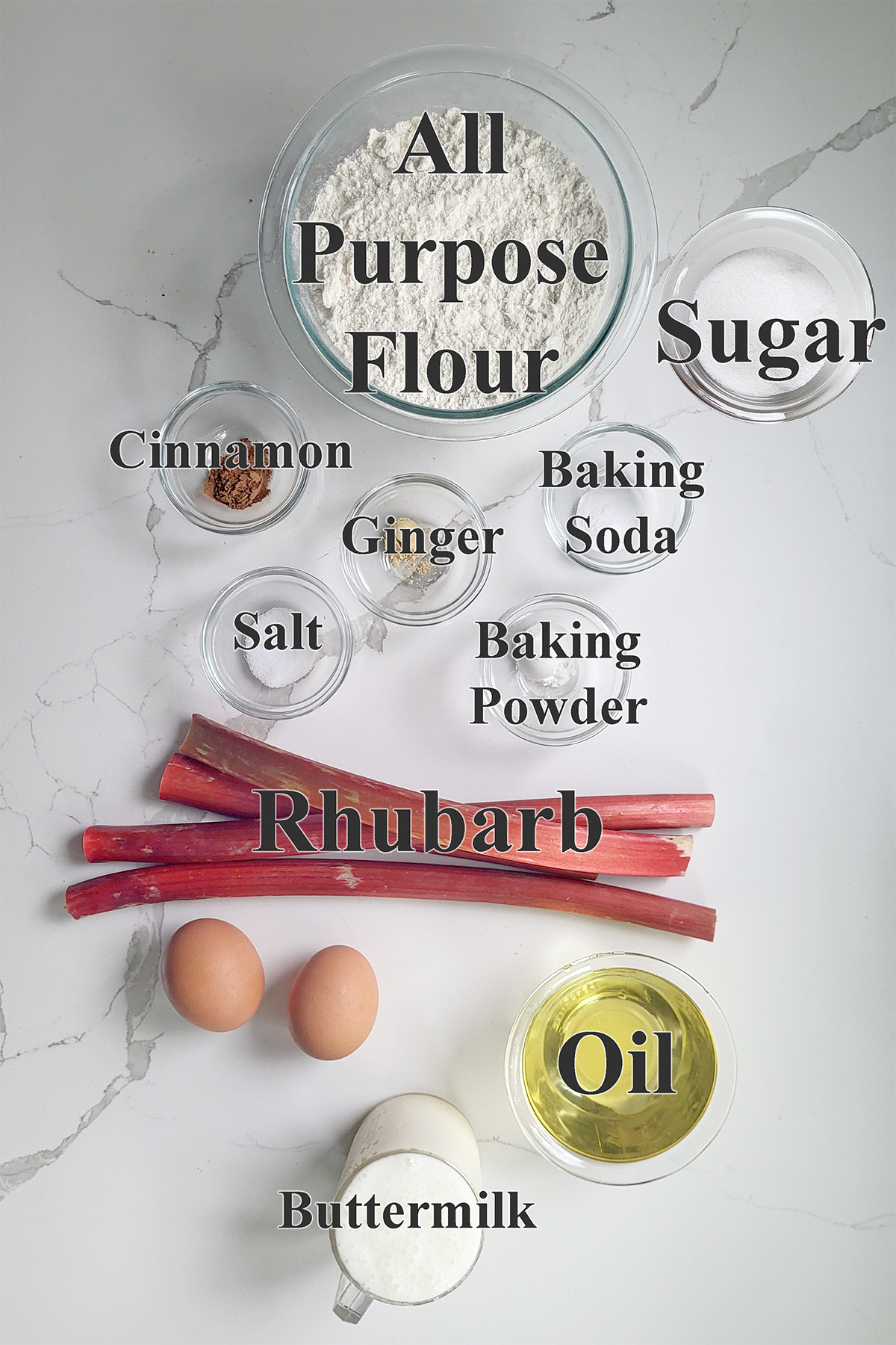 ingredients for rhubarb quick bread in glass bowls on a white surface.