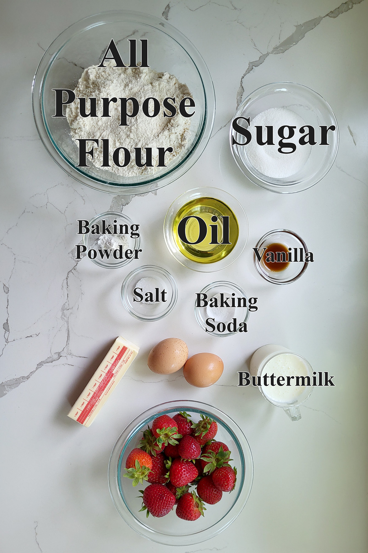 ingredients for strawberry muffins in glass bowls.