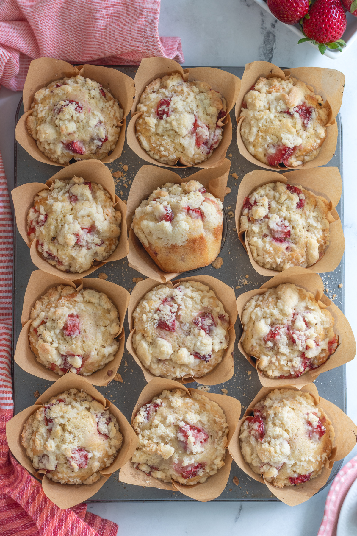 an overhead shot of a tray of strawberry muffins.