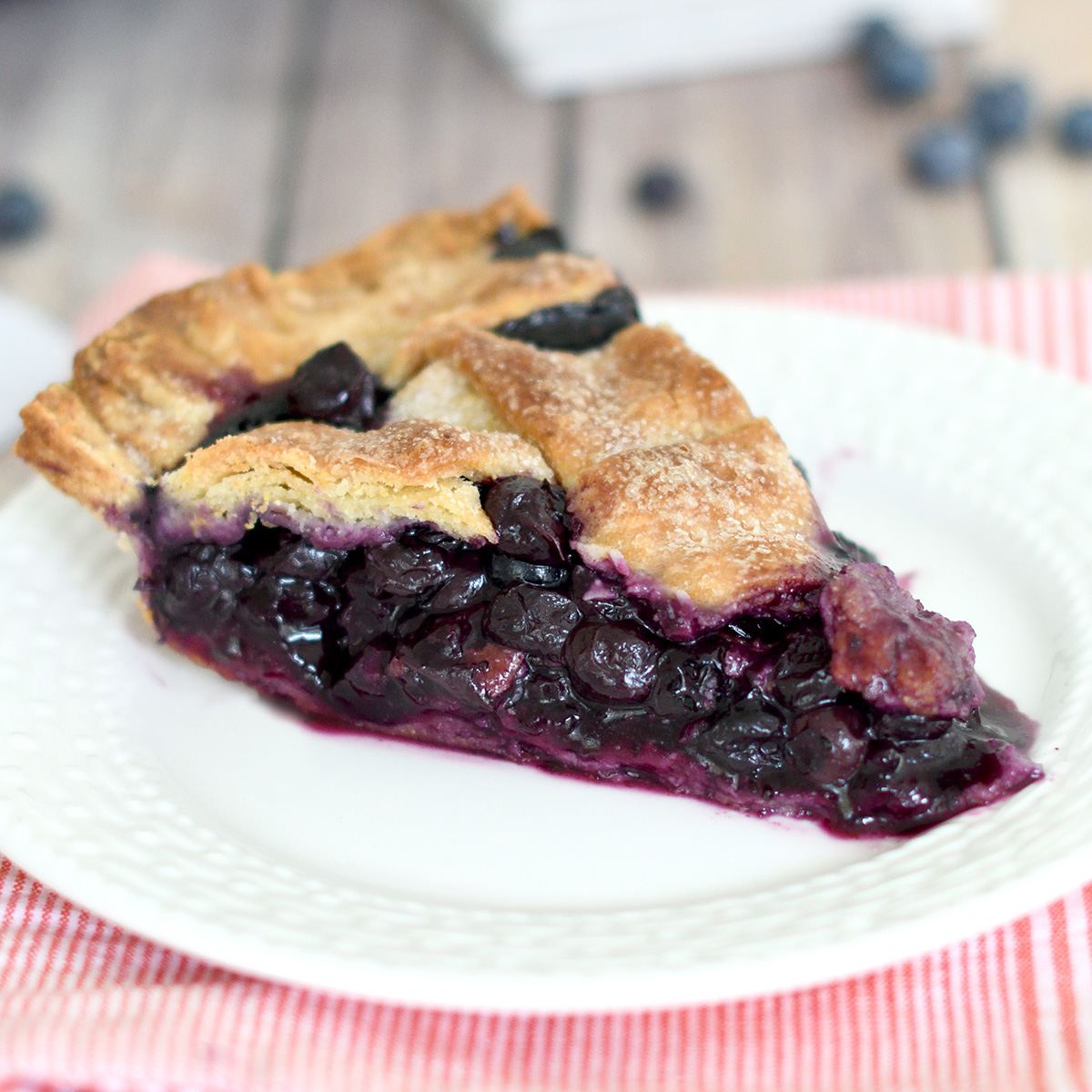 a slice of blueberry pie on a white plate.