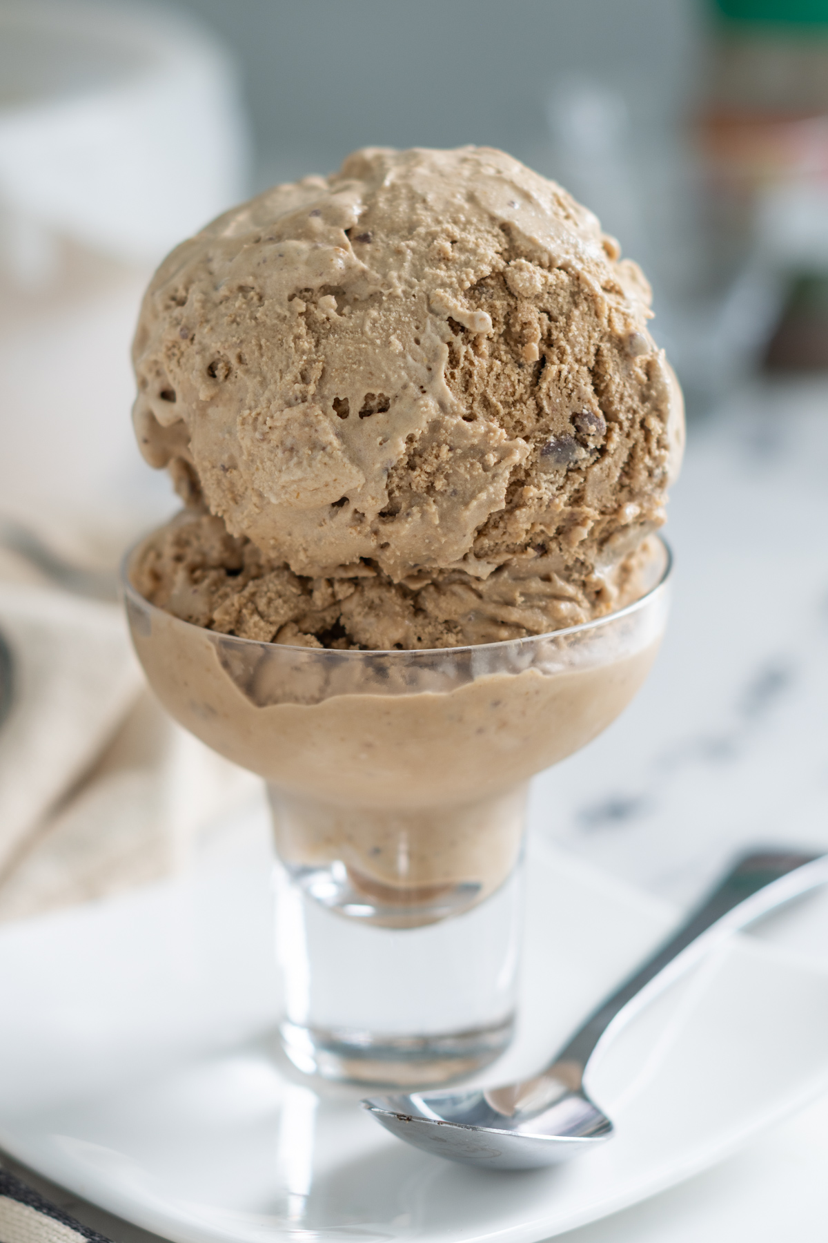 two scoop of homemade coffee ice cream in a glass bowl.