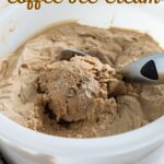 a bucket of coffee ice cream with a scooper.