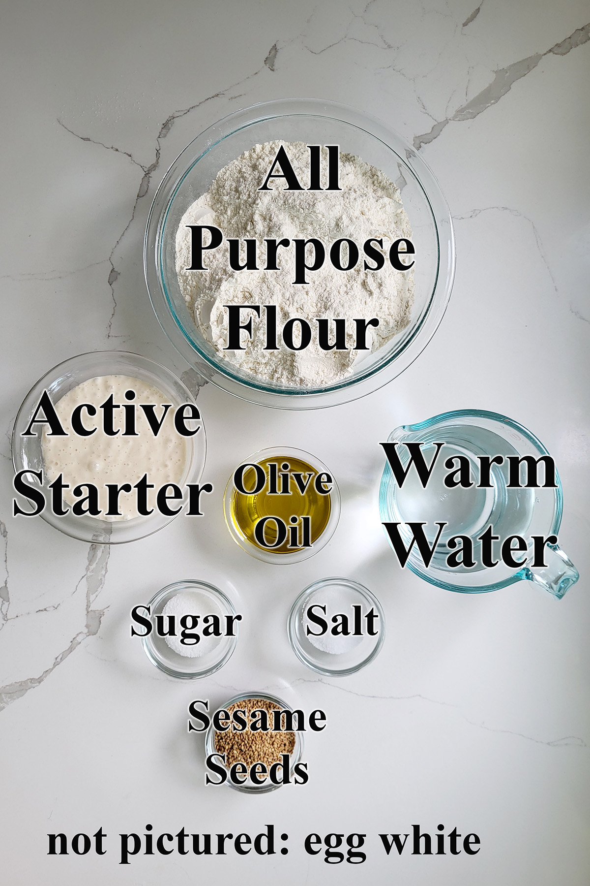 ingredients for sourdough italian bread in glass bowls.