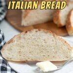 a slice of italian bread on a white plate with butter.