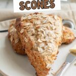 two oatmeal scones on a white plate.