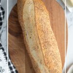 a loaf of italian bread on a wood cutting board.