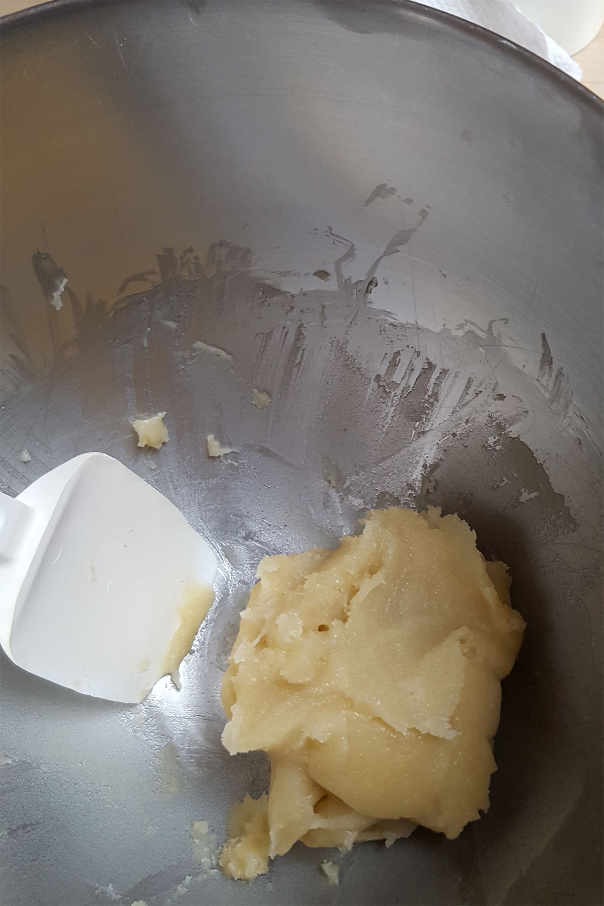 a mixing bowl with some almond paste at the bottom.