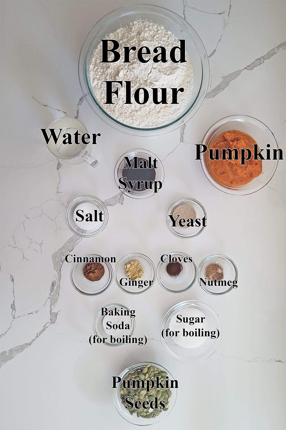 ingredients for pumpkin bagels in glass bowls on a white surface.