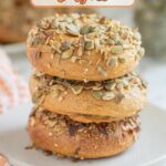a stack of pumpkin bagels on a white plate.
