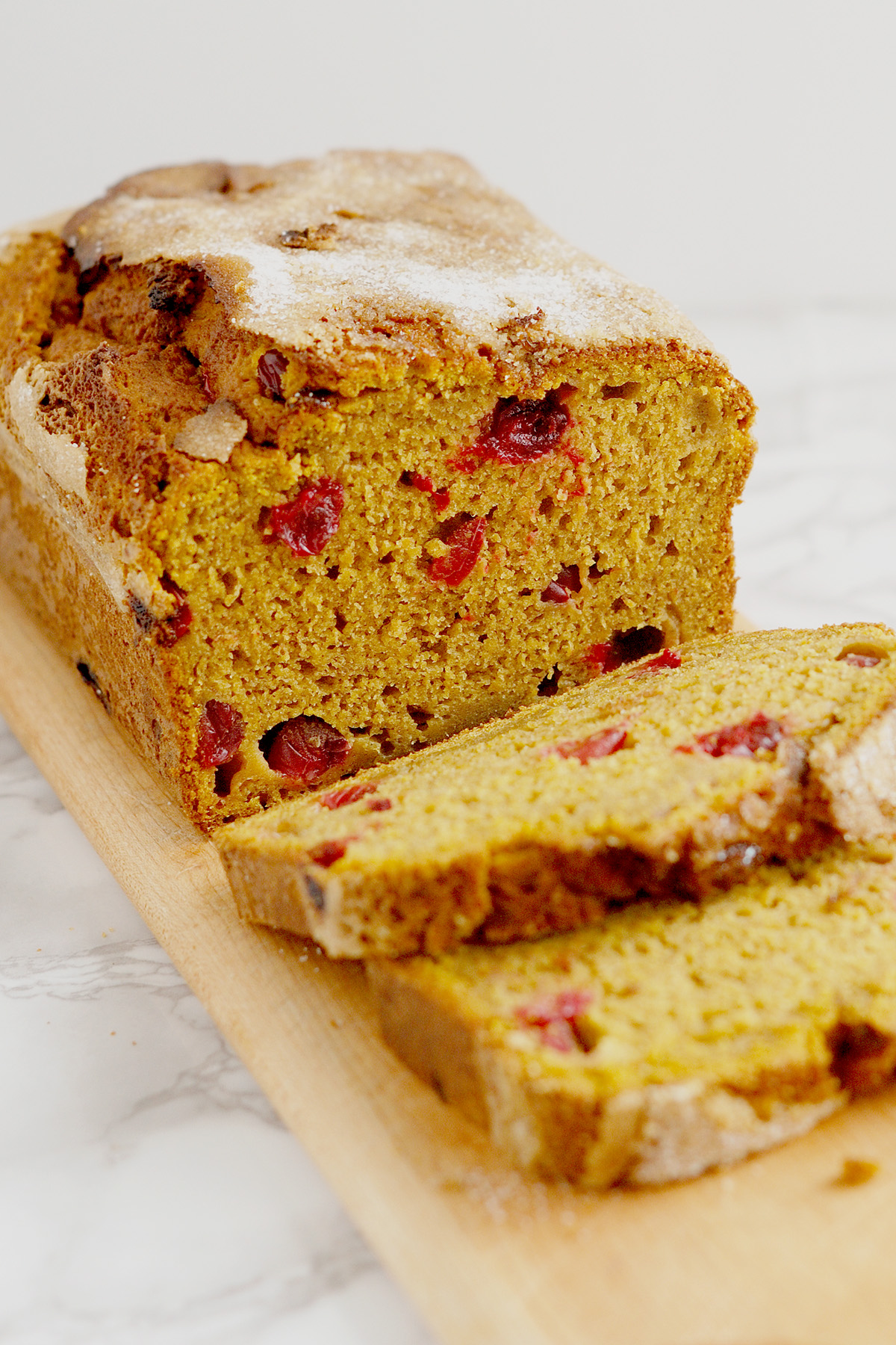 a sliced loaf of sourdough discard pumpkin bread on a cutting board.